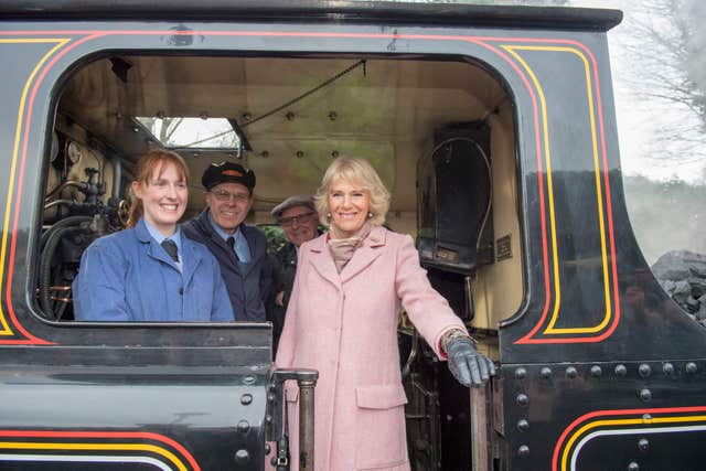 All aboard, Camilla  speaks to the driver of a steam train at The Railway Station in Haworth Arthur Edwards/The Sun/PA)