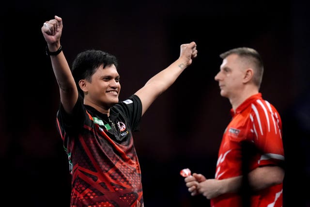 Alexis Taylo (left) reacts during his match against Krzysztof Ratajski (right) at the PDC World Darts Championship at Alexandra Palace