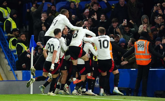 Fulham players celebrate with their fans after Rodrigo Muniz scored his side's late winn