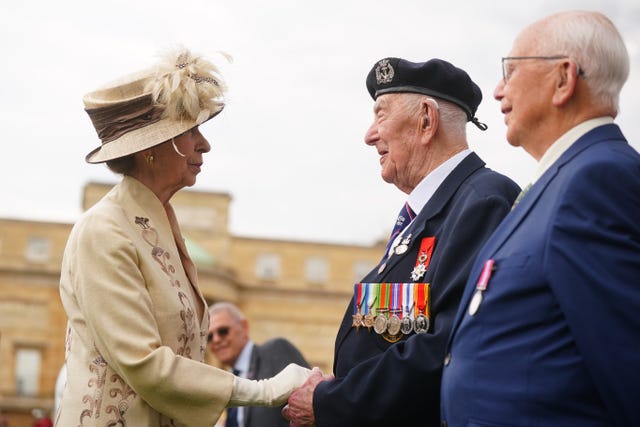 The Princess Royal speaking to D Day veterans at a garden party at Buckingham Palace