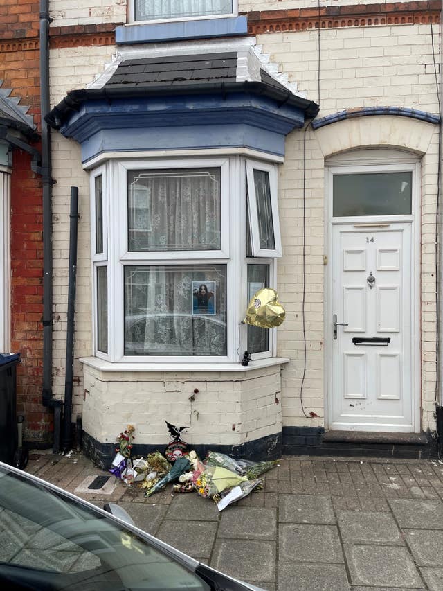 Floral and other tributes placed outside a house where Ozzy Osbourne once lived