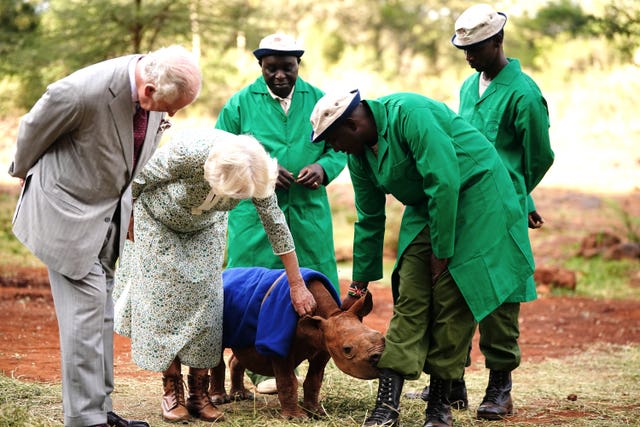 King and Queen with workers at Sheldrick Wildlife Trust Elephant Orphanage in Nairobi National Park