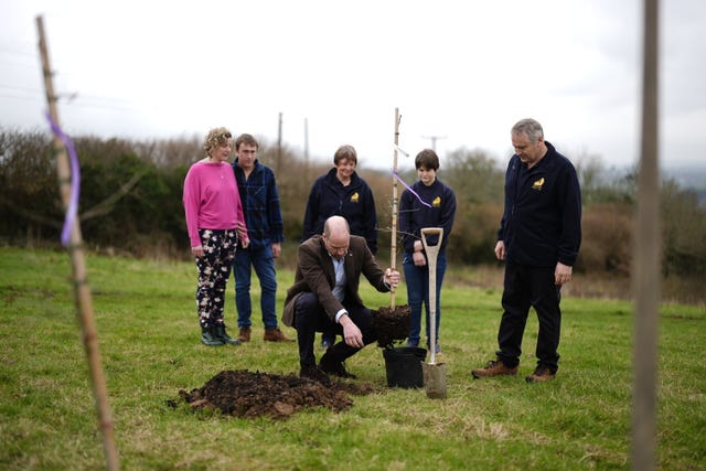 The Prince of Wales, known as the Duke of Cornwall while in Cornwall, plants a tree at an adjacent field during his visit to the Gear Farm Pasty Company, a family-run farm known for producing traditional Cornish pasties in St Martin, Helston, as he visits Cornwall for St Piran’s Day 