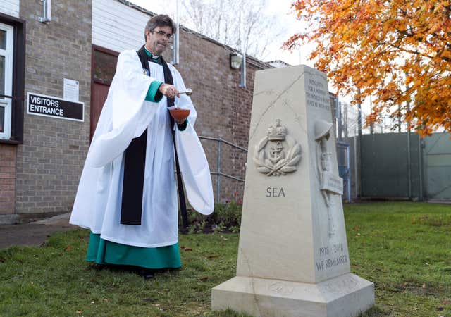 The Dean of Salisbury cathedral, the Very Reverend Nicholas Papadopulos, dedicates a war memorial outside the visitor’s centre at Erlestoke prison in Wiltshire (Andrew Matthews/PA)