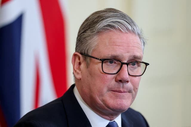 Headshot of Sir Keir Starmer speaking, with a UK flag behind him