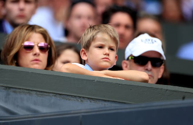 Roger Federer's wife Mirka (left) with one of his identical twin son's watch their father