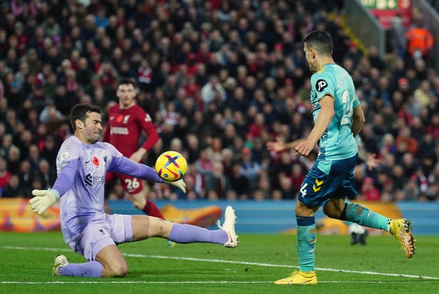 Alisson Becker (left) makes a save