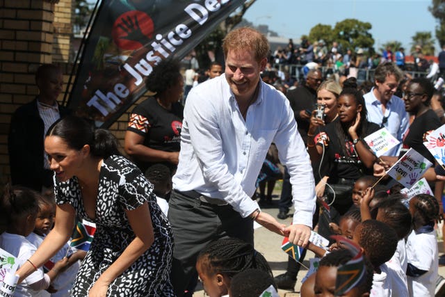 The Duke and Duchess of Sussex greeting children