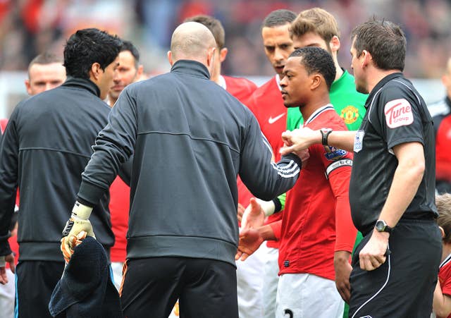 Luis Suarez (left) refused to shake Patrice Evra's hand in Liverpool's next match against Manchester United