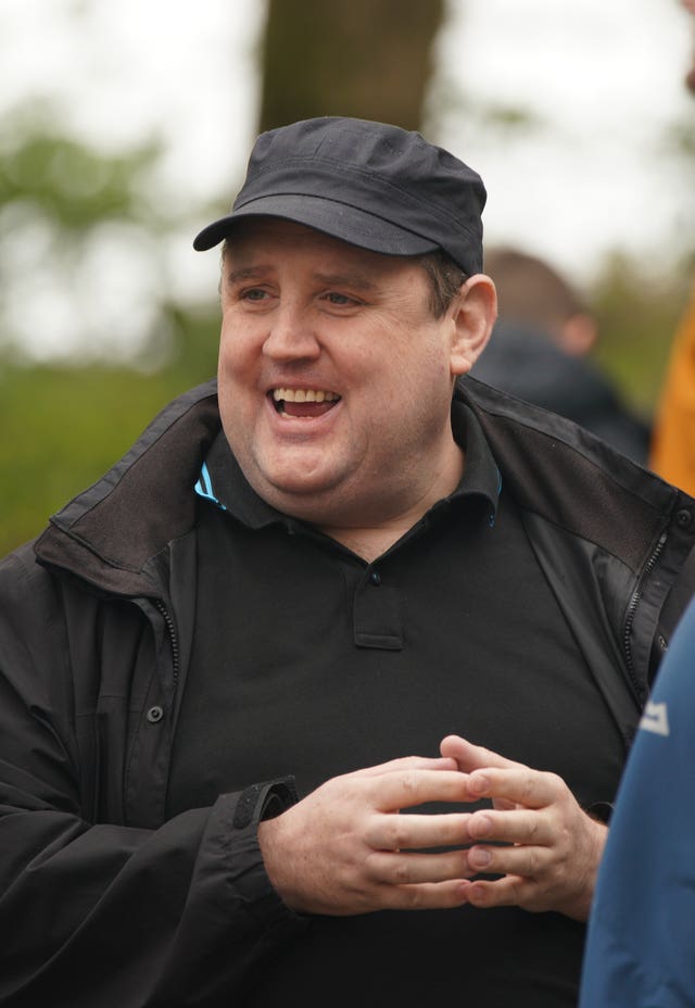 Peter Kay smiling, pictured outside