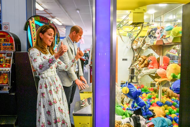 Kate's brief moment of excitement playing the claw game, before the soft toy is dropped
