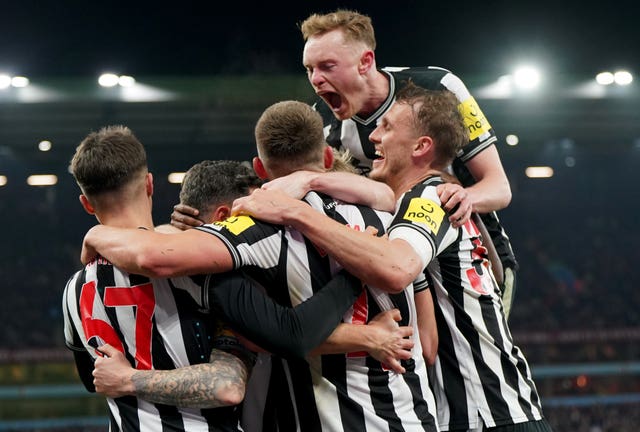 Fabian Schar, obscured, is mobbed by his team-mates after scoring his second goal