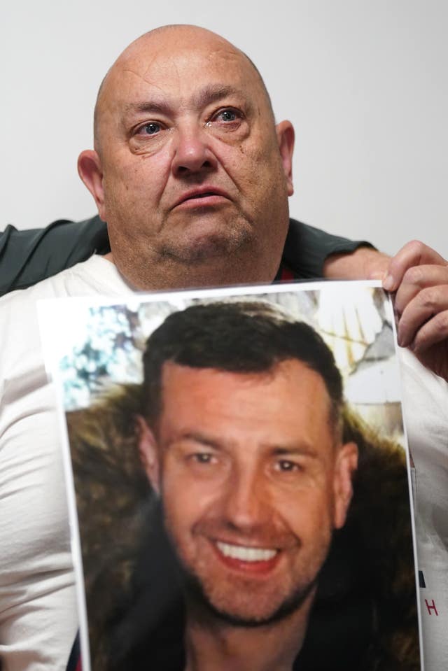 John George's father Billy holding a photograph of his son