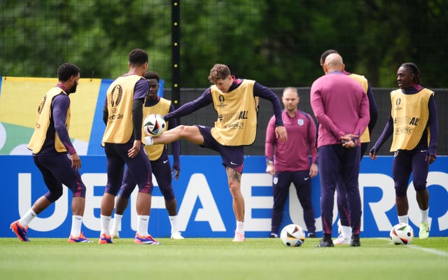 john Stones, centre, controls the ball with his foot raised during England training in Germany