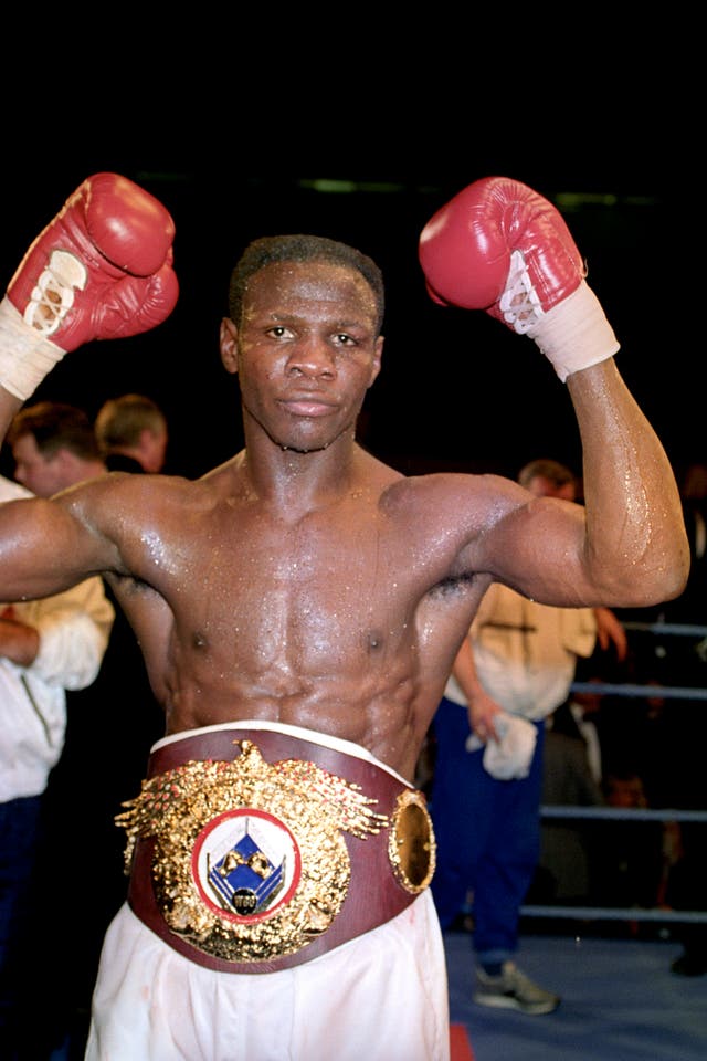 Chris Eubank raising his gloves in the air after a fight