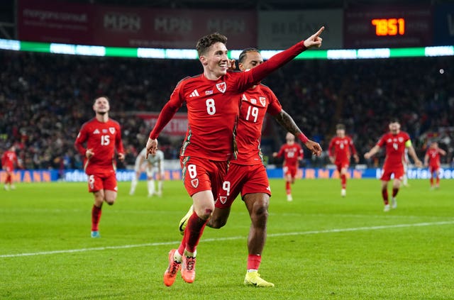 Harry Wilson puts his left hand in the air to celebrate scoring