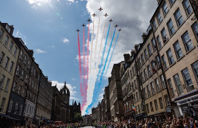 People watch a Red Arrows flypast