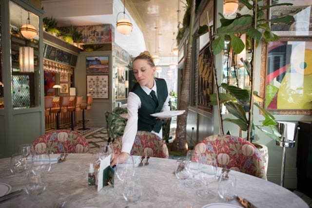 Staff at the Ivy Victoria in London prepare the dining area ahead of the final day of Eat Out To Help Out