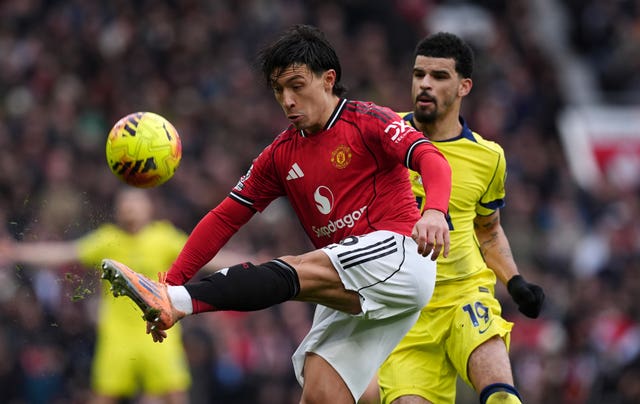 Lisandro Martinez clears the ball against Tottenham.