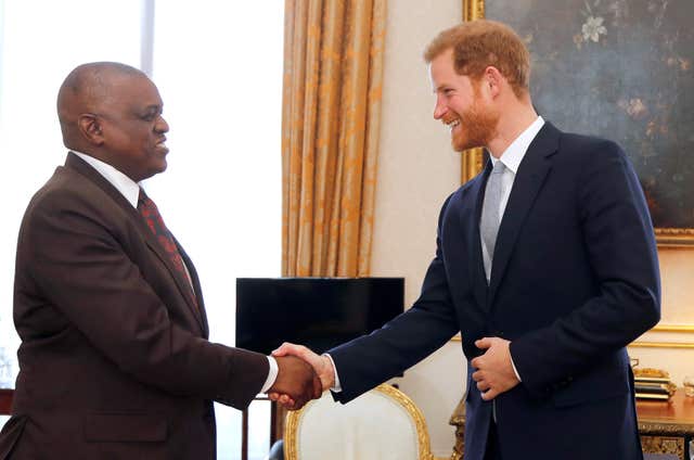 Prince Harry shakes hands with Mokgweetsi Masisi, President of Botswana, at Buckingham Palace, in London, during the Commonwealth Heads of Government Meeting. (Frank Augstein)