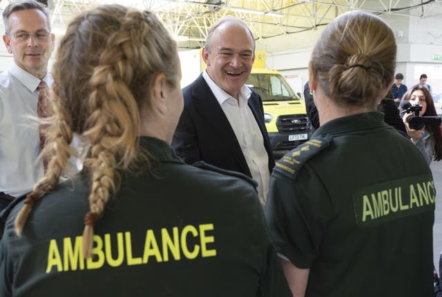 Sir Ed Davey talks to staff during a visit to Wimbledon Ambulance Station