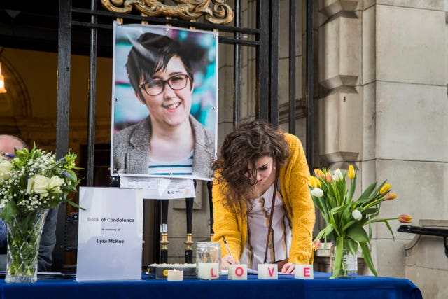 People signing a book of condolence after a vigil at Belfast City Hall in memory of murdered journalist Lyra McKee