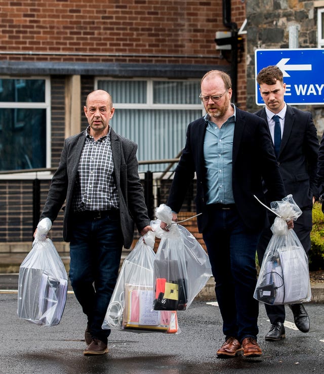 Barry McCaffrey and Trevor Birney carry away their returned documents 