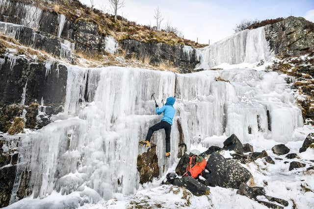 An ice climber tackles a frozen waterfall high up in Brecon Beacons National Park (Ben Birchall/PA)