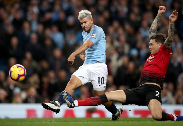 Sergio Aguero shoots after beating Manchester United's Victor Lindelof