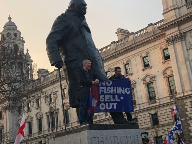 Brexit protesters climb on the statue of Winston Churchill in Parliament Square