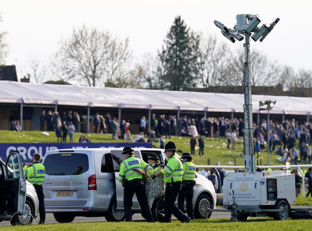 Protesters are detained by police at Aintree