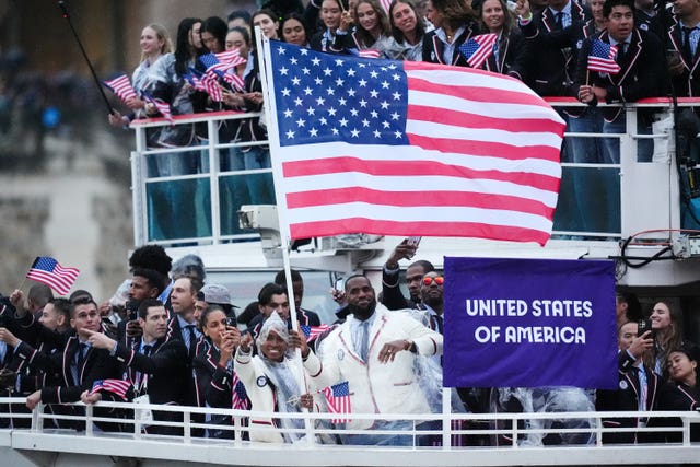 Coco Gauff and LeBron James wave the flag of the United States