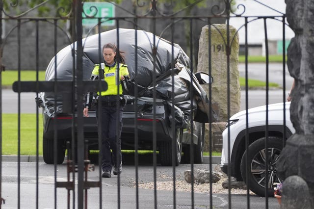 A car wrapped in plastic at the scene