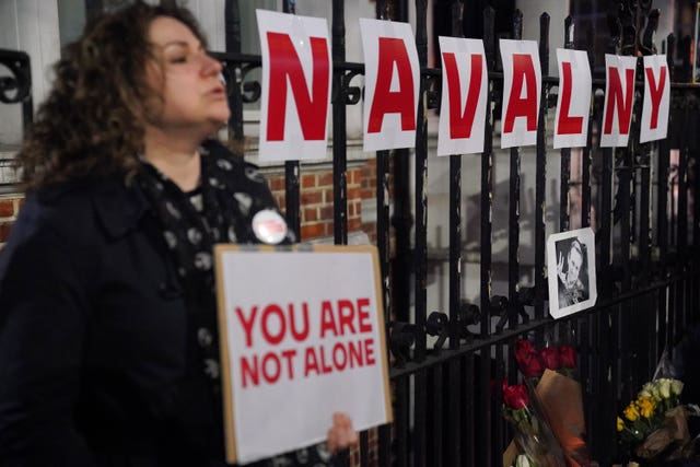 People take part in a protest opposite the Russian Embassy in London