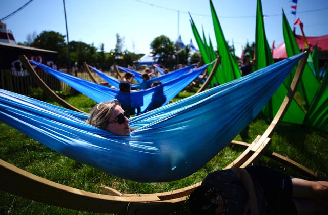 Festivalgoers make the most of hammocks set up at the festival site 