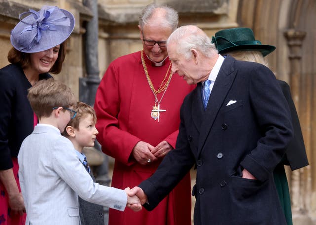 Charles shaking a young boy's hand after the Easter service