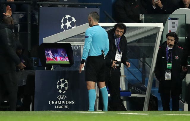 Referee Damir Skomina checks video footage on a monitor before awarding a late penalty to Manchester United