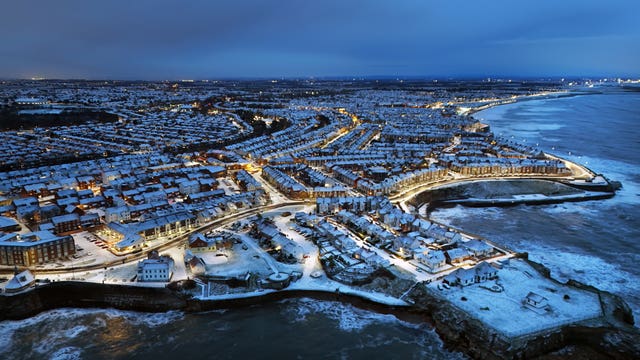 An aerial shot of Cullercoats Bay in North Tyneside covered in snow