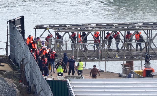 People crossing a bridge in a harbour