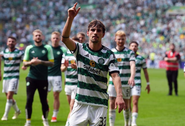 Matt O'Riley dances in front of the Celtic fans after the game against Rangers