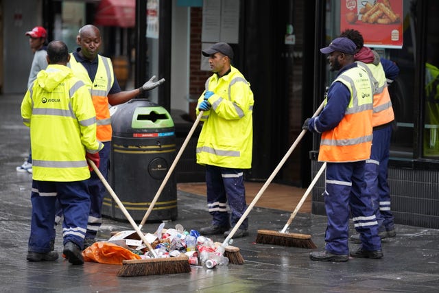 Street cleaners clear debris in London’s Leicester Square the morning after England were beaten in the final of the UEFA Euro 2020