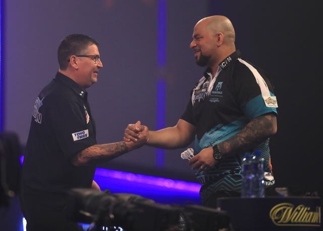Gary Anderson, left, defeated Devon Petersen to reach the quarter-finals of the PDC World Darts Championship (Adam Davy/PA)