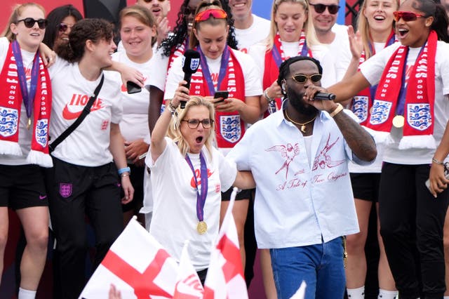 Wiegman (centre left) and Burna Boy on stage