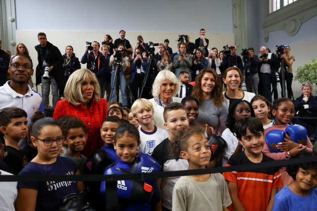 The Queen and Brigitte Macron posed with young athletes