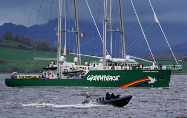 The Greenpeace ship Rainbow Warrior makes its way up the River Clyde