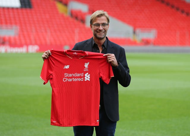 Jurgen Klopp holding a Liverpool shirt when he became manager in October 2015