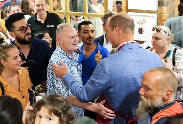 The Prince of Wales greeting Paul Gascoigne in crowd of people
