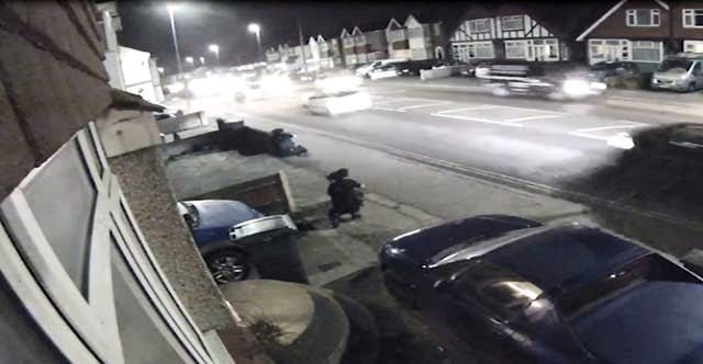 Screengrab from CCTV of Craig Savage (top left) pointing a gun at police 