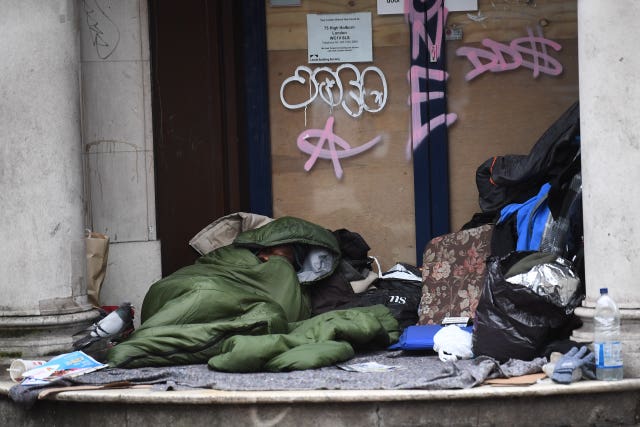 A homeless man sleeping in a doorway (Victoria Jones/PA)