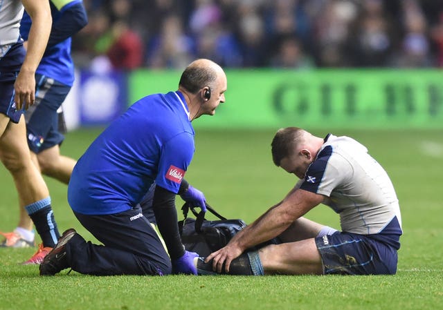 Stuart Hogg of Scotland gets treatment from Scotland team doctor Dr James Robson